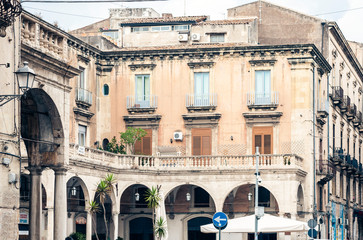 Traditional architecture of Sicily in Italy, typical street of Catania, facade of old buildings .