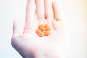 hand with pills on white background. pills in the palm.