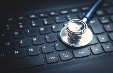 Obraz na płótnie Canvas Stethoscope on laptop keyboard. Concept of medical technology network