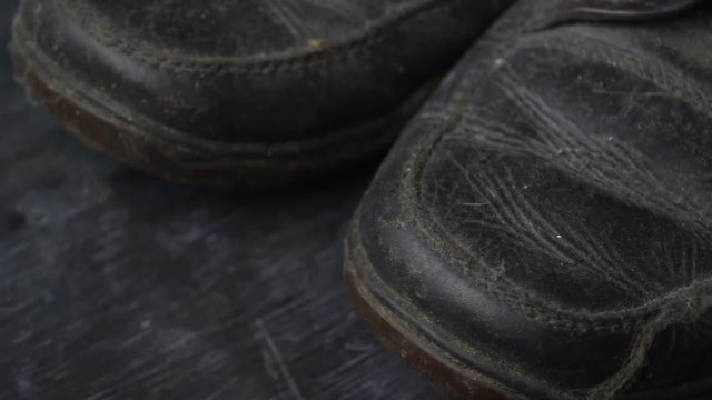 Close up of a brown old boots isolated on white background