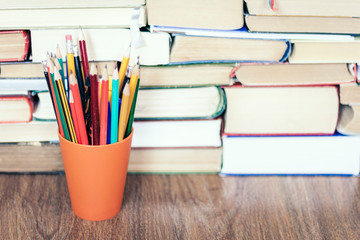 colored pencils with Stack of book education concept background.