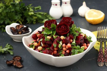 Lean chickpea and beetroot salad decorated with beetroot roses in a white salad bowl