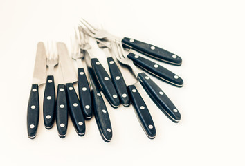 Close up six knives and forks isolated on white background.