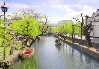 Naklejka premium People in old-fashioned boat, Kurashiki city, Japan