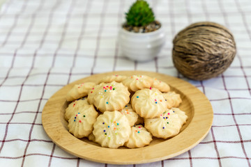Pile of cookies on wooden plate