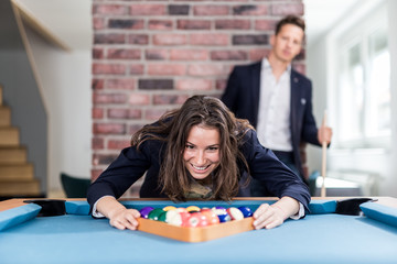 Young modern woman preparing pool balls for the next snooker game.