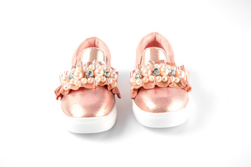 the pink children's sneakers isolated on a white background