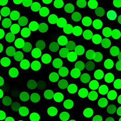 Unfocused abstract green bokeh on black background. defocused and blurred many round light