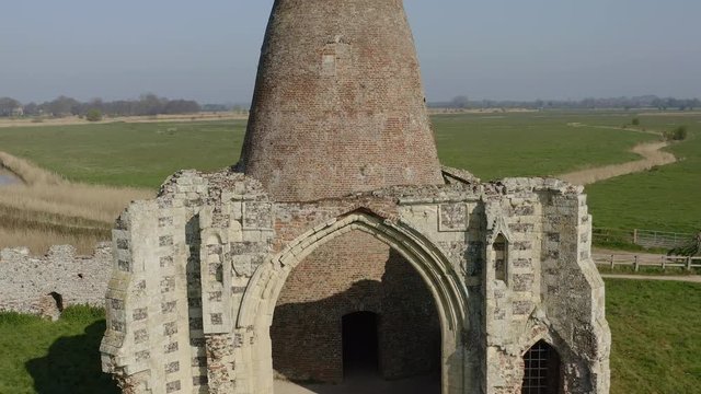 AERIAL: Crane shot of a ruined Windmill built inside of the ruins of St Benet's Abbey, Norfork, UK