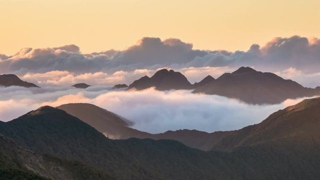 Colors of sunset evening with clouds in misty mountains nature in New Zealand wilderness Time lapse