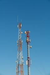 the design of the metal tower to communicate with the equipment on the background of blue sky