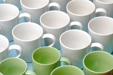 A pile of green white coffee mugs on the ground floor at the wholesale market 