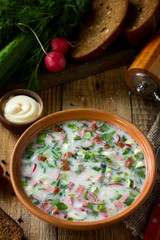 Delicious summer lunch. Spring-summer yoghurt cold soup  fresh vegetables and kefir on rustic...