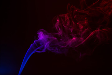 Fototapeta premium Colorful smoke close-up on a black background