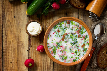Delicious summer lunch. Spring-summer yoghurt cold soup  fresh vegetables and kefir on rustic...