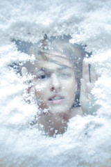 Portrait of a woman in under the ice around the snow