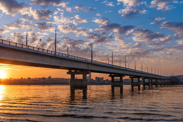 Bridge over the river at sunset - a beautiful evening landscape, Saratov Bridge across the Volga.