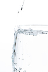 Fototapeta na wymiar A glass of water on a white background. Close-up