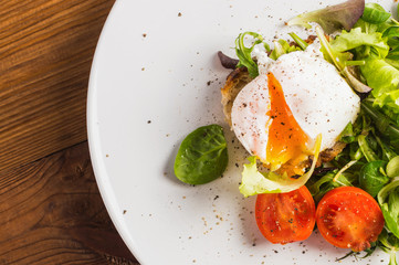 Yellow yolk, poached eggs on the plate. Gourmet food. Top view.