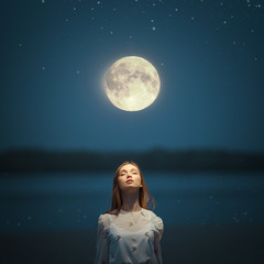 Portrait of a young attractive girl in the light of the moon.