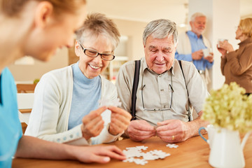 Senioren mit Alzheimer beim Puzzle spielen - obrazy, fototapety, plakaty