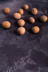 Bunch of whole walnuts on dark blue slate background. Healthy diet composition, background