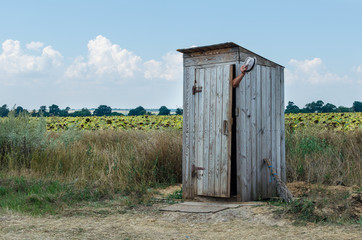 Old rural wooden toilet in the field