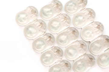 Stack of disposable contact lenses isolated on white. The concept of eye health