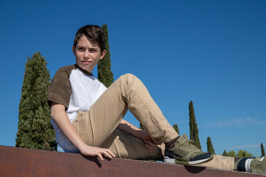 Portrait of a 13-year-old boy with blue background sky