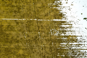 Aerial view of agricultural field appears from under the snow