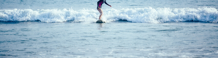  Surfer girl sit on the surfboard beach at sunrise