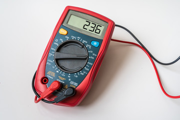 Red digital multimeter - isolated on white background