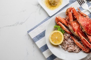 Cooked Steamed red crab on white plate food concept background, top view.