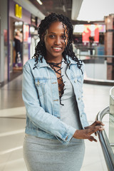Young dark-skinned woman dressed in casual clothes in the mall