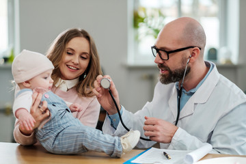 Mother with baby visiting pediatrician