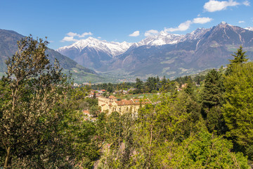 Fototapeta premium Panorama of Castle Trauttmansdorff between a green Alps landscape and botanical garden of Meran. Merano, Province Bolzano, South Tyrol, Italy.