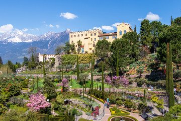 Panoramic view on Castle and botanical gardens of Trauttmansdorff in a Alps landscape of Meran. Merano, Province Bolzano, South Tyrol, Italy. - obrazy, fototapety, plakaty
