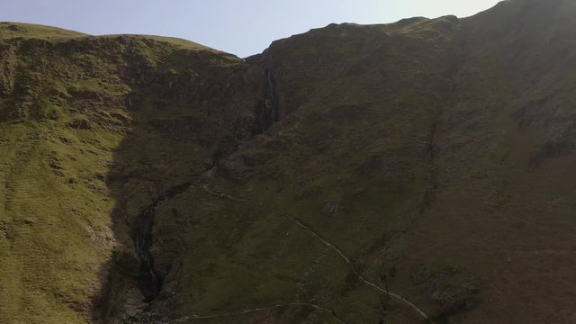 Drone waterfall pull back ascend shot from Knott Rigg and Ard Crags in The Lake District, Cumbria