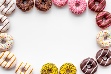 Modern design with bright donuts frame on white background top view mock up