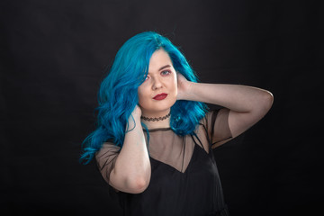 People, style and fashion concept - Close up portrait of young woman with blue long hair dressed in black dress