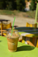 Coffee to go on green table