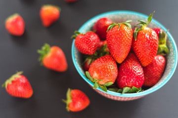 strawberries in the bowl on black background