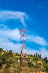 High voltage power lines on a hill  . Electrical tower over residential buildings in Istanbul, Turkey 