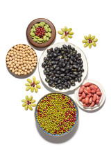 Dry peanuts and variety of beans in plate isolated on white background