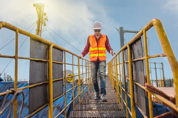 legs of engineering, technician, motorman, worker hurry up running upstair on handrail ladder to...