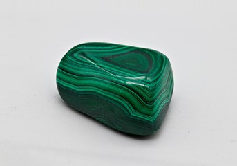 Green polished shiny malachite stone sample isolated on white limbo background
