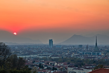 Obraz premium Aerial view on Torino cityscape during a sunset in a foggy spring day, sky is milky and colorful