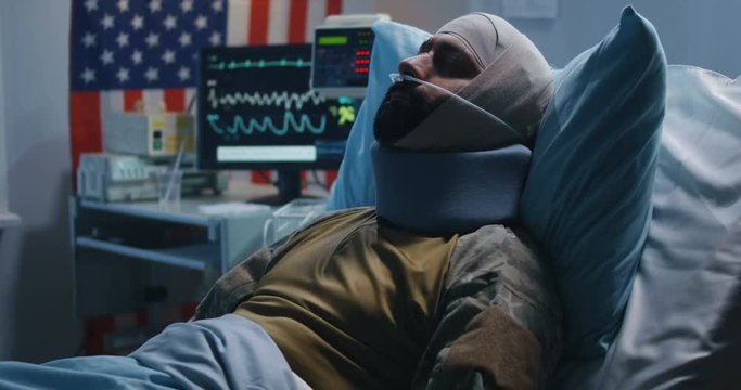 Injured soldier lying in hospital bed