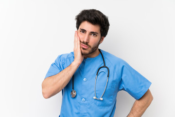 Surgeon doctor man over isolated white wall unhappy and frustrated