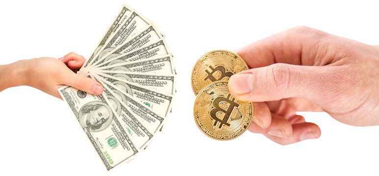 Golden Bitcoins on US dollars in the hands